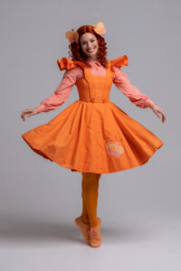 Emma Memma in an orange dress
